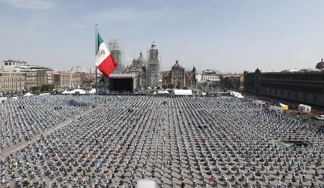People attend a mass trampoline class in Mexico City, Mexico, 23 October 2022. The Zócalo of the Mexican capital was the setting where the Guinness Record was set for “The World's Largest Fitness Trampoline Class”, when 3,935 participants gathered. After participating during the 30-minute class, the Head of Government of Mexico City, Claudia Sheinbaum stressed that the new Guinness Record shows that Mexico City is the most sporty in the world. (Photo by Mario Guzmán/EPA/EFE)