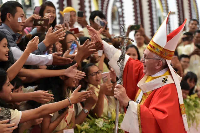 Pope Francis blesses faithful during a Mass at St Mary's Cathedral in Yangon, Myanmar November 30, 2017. (Photo by Osservatore Romano/Reuters)