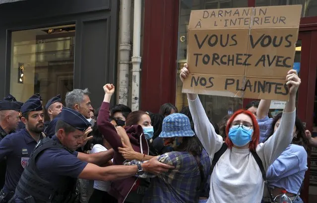 French CRS riot police block feminist protesters holding banners reading 'Darmanin at the Interior ministry: you don't care about our complaints' in Paris on July 7, 2020 as Gerald Darmanin has been appointed French newly Interior Minister following a Cabinet reshuffle. Appeals judges in Paris in June 2020 have ordered the reopening of an investigation into rape allegations dating from 2009 against Darmanin. (Photo by Geoffroy van der Hasselt/AFP Photo)