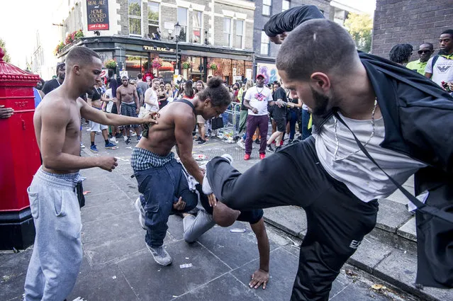 A fight breaks out at the annual Notting Hill Carnival, at Notting Hill in west London, Monday 29 August 2016. (Photo by Euan Cherry/UPPA)