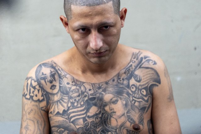 A prisoner at the Terrorist Confinement Center stands shackled against a wall as the U.S. Homeland Security secretary tours the facility, in Tecoluca, El Salvador, March 26, 2025. (Photo by Alex Brandon/AP Photo)