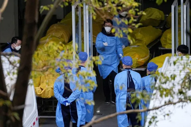 A staff member walks next to several body bags at a funeral home, as COVID-19 outbreaks continue in Shanghai, China on January 4, 2023. (Photo by Reuters/China Stringer Network)