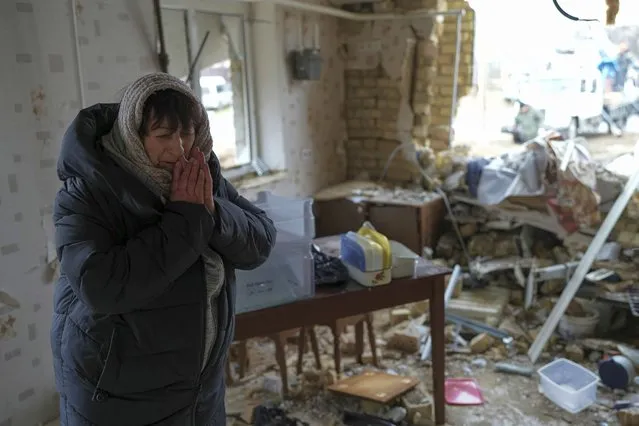 Halina Panasian, 69, reacts inside her destroyed house after a Russian rocket attack in Hlevakha, Kyiv region, Ukraine, Thursday, January 26, 2023. (Photo by Roman Hrytsyna/AP Photo)