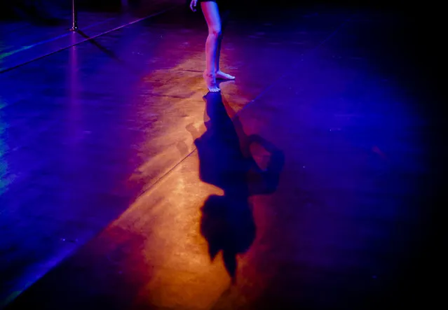 In this September 10, 2016 picture, Diana Romaniuc, 7 years-old, casts a shadow on the floor while performing in the children category of the Romania Miss Pole Dance Contest, ahead of the finals of the Pole Sport&Fitness World Championship 2016 in Bucharest, Romania. (Photo by Vadim Ghirda/AP Photo)