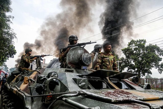 Army personnel patrol a street on an armoured vehicle after Awami League party activists allegedly clashed with security personnel to rebuke a rally by the newly formed Jatiya Nagarik Party, or National Citizen's Party in Gopalganj on July 16, 2025. At least three were killed and a dozen others injured in Gopalganj on July 16, after a clash broke out between law enforcement agencies and alleged Awami League affiliates attempting to foil a programme by the National Citizens Party (NCP). (Photo by Anik Rahman/AFP Photo)