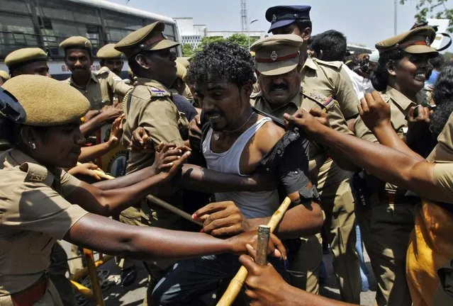 Police detain a college student during a protest in the southern Indian city of Chennai March 27, 2013. Dozens of students on Wednesday held a protest against Sri Lanka demanding the probe into war crimes, the protesting students said. The United Nations urged Sri Lanka in a resolution last week to carry out credible investigations into killings and disappearances during its nearly 30-year civil war, especially in the brutal final stages in 2009. (Photo by Babu/Reuters)
