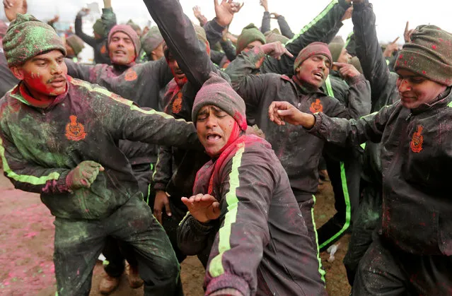 Indian Border Security Force (BSF) soldiers, with faces smeared with coloured powder, dance during Holi celebrations in a camp in Humhama on the outskirts of Srinagar March 2, 2018. (Photo by Danish Ismail/Reuters)