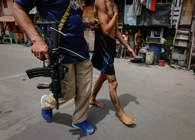 An alleged drug user is arrested during a police operation against illegal drugs at a slum area in Manila, Philippines, 06 October 2016. According to reports, three people were killed by the police during the operation, a couple of days after Philippine President Rodrigo Duterte lashed out in response to EU and US criticism of the anti-drug campaign launched by his government. Since Duterte took office on June 30, more than 3,500 people have been killed in military operations and extrajudicial executions carried out as part of the anti-drug campaign, according to reports. (Photo by Mark R. Cristino/EPA)