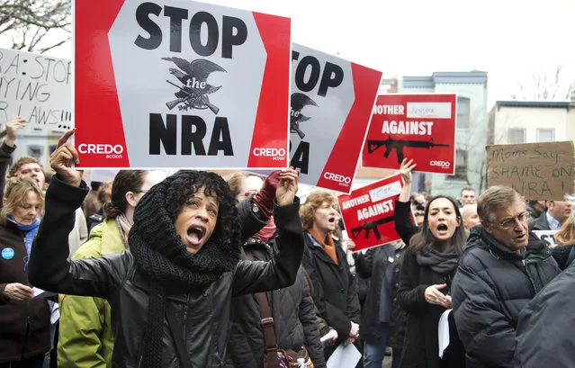 Tasha Devoe, left, of Lawrence, Mass., joins a march to the National Rifle Association headquarters on Capitol Hill in Washington Monday, December 17, 2012. Curbing gun violence will be a top priority of President Barack Obama's second term, aides say. but exactly what he'll pursue and how quickly are still evolving. (Photo by Manuel Balce Ceneta/AP Photo)