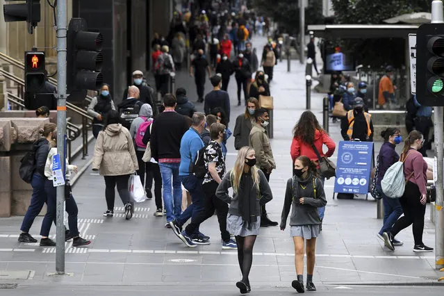 People wearing face mask walk along Bourke Street Mall in Melbourne, Friday, November 6, 2020. Australia’s highest court on Friday upheld a state’s border closure and dismissed billionaire businessman Clive Palmer’s argument that the pandemic measure was unconstitutional. (Photo by James Ross/AAP Images via AP Photo)