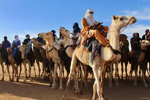 In this photo taken Saturday February 17, 2018, Tuareg men ride on camels during a festival in Iferouane, Niger. (Photo by Ludivine Laniepce/AP Photo)