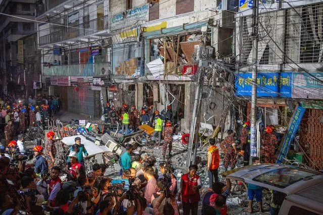 Firefighters inspect the site of an explosion at Siddique Bazar area in Dhaka, Bangladesh, 07 March 2023. Sixteen people died and scores were injured, according to the Dhaka Fire service and Police authority. The reason behind the explosion is yet to be determined. (Photo by Monirul Alam/EPA/EFE/Rex Features/Shutterstock)