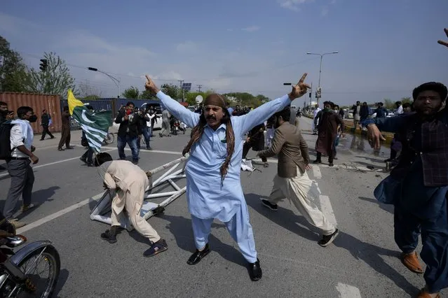 Supporters of former Prime Minister Imran Khan chant anti government slogans during clashes, in Islamabad, Pakistan, Saturday, March 18, 2023. (Photo by Anjum Naveed/AP Photo)