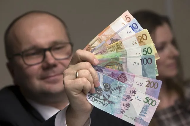 Deputy Chairman of the Board of the National Bank of the Republic of Belarus Dmitry Lapko displays a sample banknote during a news conference in Minsk, November 10, 2015. Belarus plans to lower the denomination of the Belarusian rouble by July 1, 2016, according to local media. (Photo by Vasily Fedosenko/Reuters)
