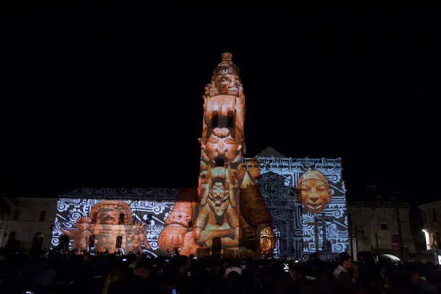 Thousands of pedestrians gather downtown for a lighting and chromalithe exhibition on a catholic church, as part of the UN Habitat III conference in Quito, Ecuador October 18, 2016. (Photo by Guillermo Granja/Reuters)