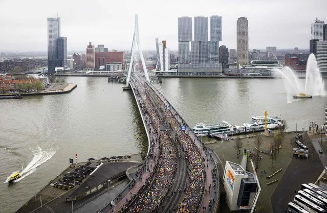 Participants run across the Erasmus Bridge during the 42nd edition of the Rotterdam Marathon on April 16, 2023. (Photo by Jeffrey Groeneweg/ANP via AFP Photo)