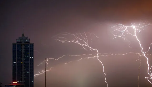 Lightning strikes behind commercial tower near a financial city in Colombo, Sri Lanka November 22, 2017. (Photo by Dinuka Liyanawatte/Reuters)