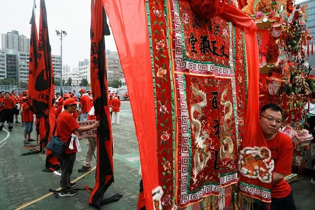 Participants hold flags during a parade celebrating Tin Hau festival at Yuen Long district, in Hong Kong, China on May 12, 2023. (Photo by Lam Yik/Reuters)