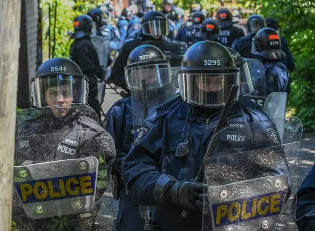 Police block an alley during a demonstration in Quebec City on June 8, 2018, as the G7 Summits gets underway. (Photo by Martin Ouellet-Diotte/AFP Photo)