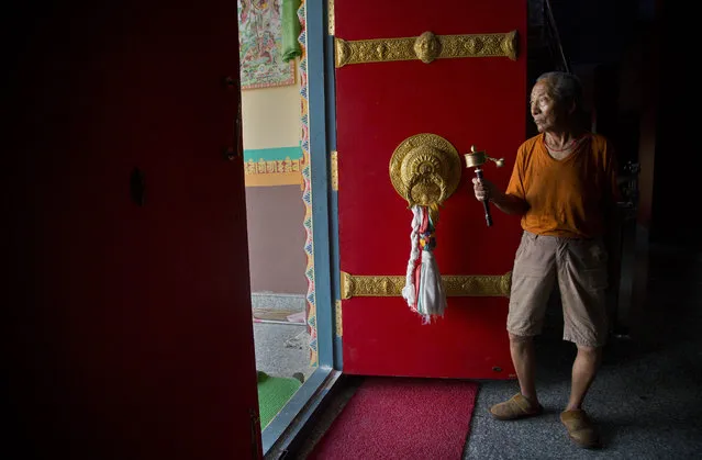 A Buddhist worshipper turns a prayer wheel inside a monastery in Dehradun, India, Monday, June 4, 2018. (Photo by Anupam Nath/AP Photo)