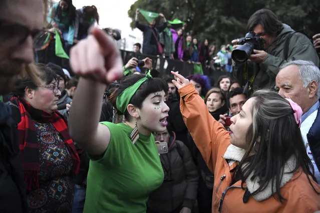 A pro- choice activist (L) argues with a woman opposed to the legalization of abortion outside the Argentine Congress in Buenos Aires, on June 13, 2018. Lawmakers in traditionally conservative Argentina began a key session on Wednesday ahead of a divisive vote on a bill to legalize abortion. (Photo by Eitan Abramovich/AFP Photo)