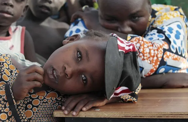 A girl displaced as a result of Boko Haram attack in the northeast region of Nigeria, rests her head on a desk at Maikohi secondary school camp for internally displaced persons (IDP) in Yola, Adamawa State January 13, 2015. (Photo by Afolabi Sotunde/Reuters)