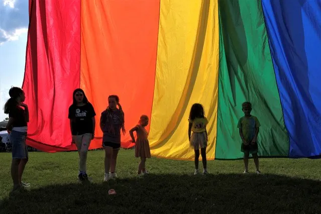 Children of attendees hold the rainbow flag during an all ages LGBTQ Pride event in Franklin, Tennessee, U.S., June 3, 2023. (Photo by Kevin Wurm/Reuters)
