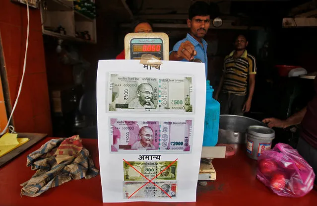 A notice is pasted at a shop stating the refusal of the acceptance of the old 500 and 1000 Indian rupee banknotes and acceptance of the new 500 and 2000 Indian rupee banknotes, in Allahabad, India, November 10, 2016. (Photo by Jitendra Prakash/Reuters)
