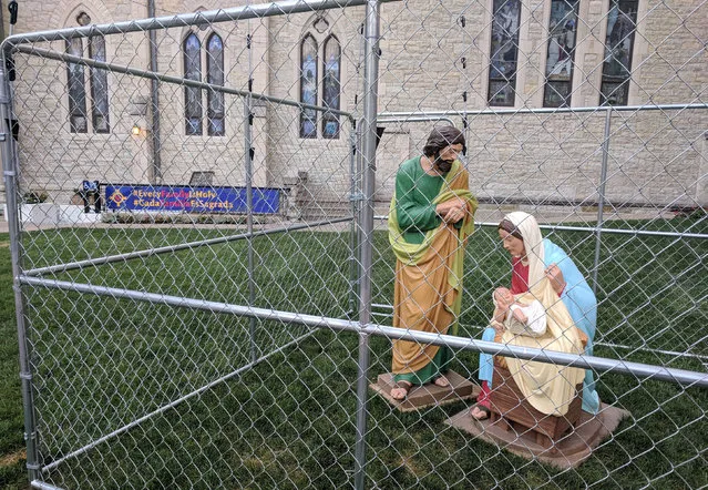 The statues of Jesus, Mary and Joseph are seen in a cage as a protest of child separation policy, in Indianapolis, Indiana, U.S., July 2, 2018 in this picture obtained from social media. (Photo by Christ Church Cathedral Indianapolis/via Reuters)