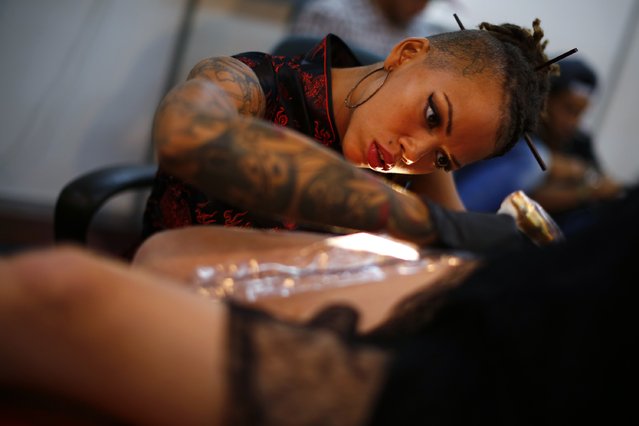 A woman is tattooed at Venezuela Expo Tattoo in Caracas January 29, 2015. (Photo by Jorge Silva/Reuters)