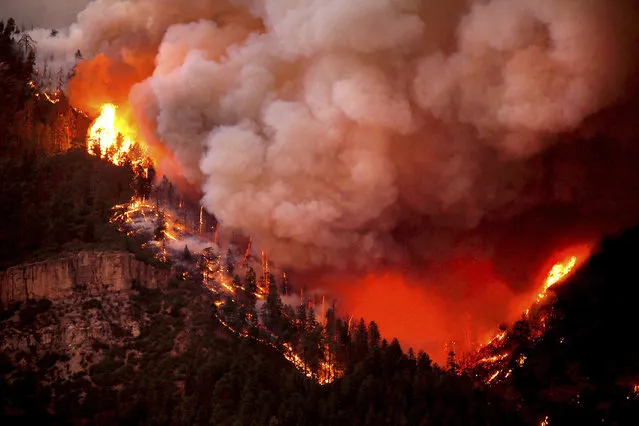 In this photo taken Wednesday, June 6, 2018, the 416 Fire burns down Hermosa Cliffs above U.S. Highway 550 on the southeast side of the fire near Hermosa, Colo. (Photo by Jerry McBride/Durango Herald via AP)