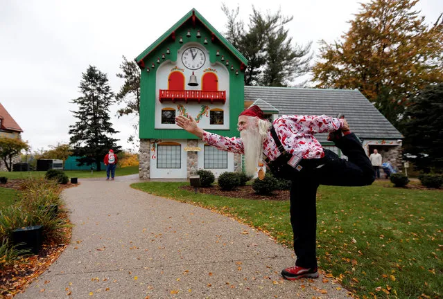 Santa Jerry Julian of Colorado Springs, Colorado shows some yoga moves outside the Santa House in Midland, Michigan, U.S. October 27, 2016. (Photo by Christinne Muschi/Reuters)
