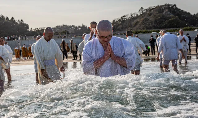 Buddhist monks pray for the victims of the 2011 Tohoku earthquake and tsunami at a beach on March 11, 2021 in Iwaki, Japan. Japan will today observe the 10th anniversary of the 2011 Tohoku earthquake, tsunami and triple nuclear meltdown in which almost 16,000 were killed and hundreds of thousands made homeless. The magnitude 9.0 earthquake was one of the most powerful ever recorded. It triggered tsunami waves up to 40.5 meters high that travelled at 700km/h and surged up to 10km inland destroying entire towns. It moved Japan’s main island of Honshu 2.4m east, shifted the Earth on its axis by estimates of between 10cm and 25cm and increased the planet’s rotational speed by 1.8 microseconds per day. (Photo by Yuichi Yamazaki/Getty Images)