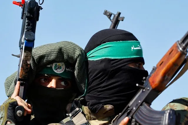 Palestinian fighters from the armed wing of Hamas take part in a military parade to mark the anniversary of the 2014 war with Israel, in the central Gaza Strip on July 19, 2023. (Photo by Ibraheem Abu Mustafa/Reuters)