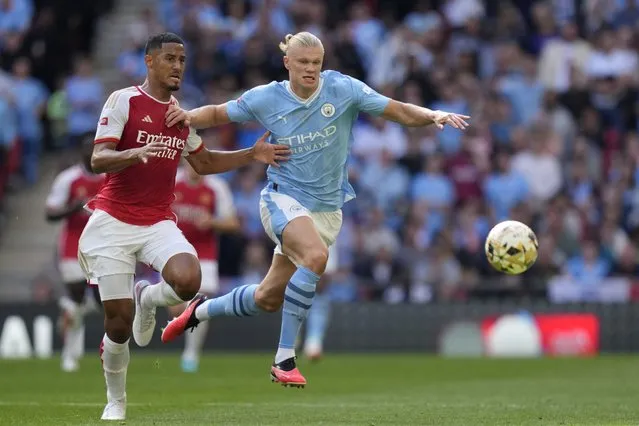 Arsenal's William Saliba, left, challenges for the ball with Manchester City's Erling Haaland during the English FA Community Shield final soccer match between Arsenal and Manchester City at Wembley Stadium in London, Sunday, August 6, 2023. (Photo by Kirsty Wigglesworth/AP Photo)