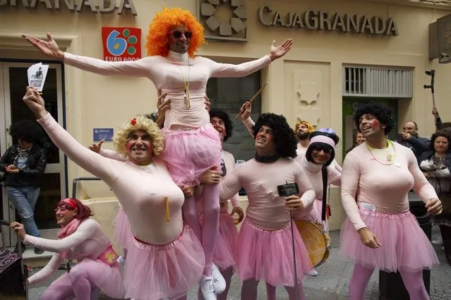 Men in fancy costumes perform in a street during the Carnival of Cadiz, southern Spain February 15, 2015. (Photo by Marcelo del Pozo/Reuters)