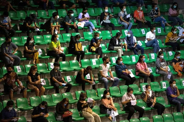People take seats within a sport stadium while waiting to receive vaccination with the CoronaVac vaccine developed by Sinovac firm on April 22, 2021 in Phuket, Thailand. Thailand's tourism-driven economy has been battered by the country's borders being closed for a prolonged period, and a recent rise in Covid-19 cases has caused further concern as the government imposed fresh restrictions to control the outbreak. The country has lagged behind on the delivery of vaccines to the general population, a key step required to reopen the economy to tourism. (Photo by Sirachai Arunrugstichai/Getty Images)