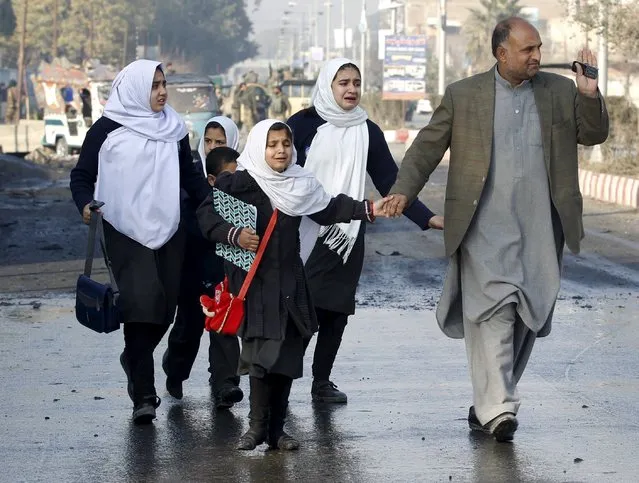 School children react as they were led away after a blast near the Pakistani consulate in Jalalabad, Afghanistan January 13, 2016. (Photo by Reuters/Parwiz)