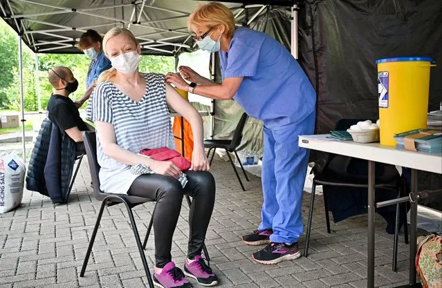 Members of the public on the South Side of the city who are over forty receive their covid vaccination at a car park on June 02, 2021 in Glasgow, Scotland. Scotland's national clinical director, Prof Jason Leitch, said the country was entering a third wave of Covid-19 cases as lockdown restrictions eased, but added, “The question is how big that third wave is”. Yesterday, Scottish First Minister Nicola Sturgeon announced that 13 council would remain in level two of its five-tier pandemic risk system, rather than drop to level one as scheduled. (Photo by Jeff J. Mitchell/Getty Images)