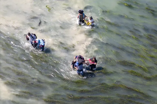 In an aerial view, immigrants struggle through the current of the Rio Grande while crossing from Mexico into the United States on September 27, 2023 in Eagle Pass, Texas. A surge of asylum seeking migrants crossing the U.S. southern border has put pressure on U.S. immigration authorities, reaching record levels during the last week. (Photo by John Moore/Getty Images)