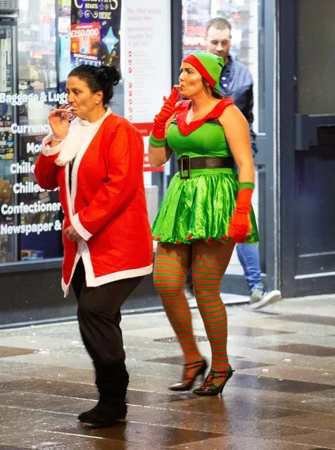 Mrs Christmas and her elf helper head out for a night on the town in Cardiff, England on December 21, 2018. Christmas celebrations kicked off with a bang in Blackpool, Birmingham, and Cardiff. (Photo by South West News Service)