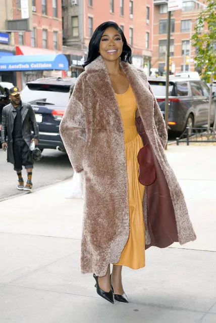Gabrielle Union is pictured stepping out in New York City on November 9, 2023. The American actress wore a faux fur trench coat, yellow dress, and black heels. (Photo by The Image Direct)