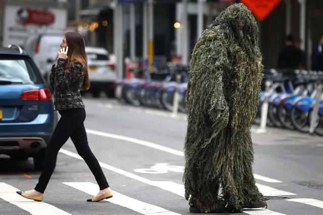 A man in a costume waits to cross a street in midtown Manhattan on Halloween day in New York City, New York, U.S., October 31, 2022. (Photo by Mike Segar/Reuters)