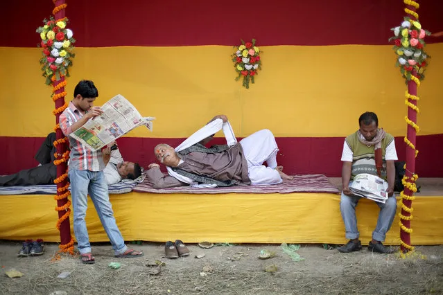 An Indian devotees rest at a makeshift tent inside a transit religious gathering ahead of Ganga Sagar annual fair in Calcutta, eastern India 09 January 2017. The Gangasagar Fair is an annual gathering of Hindu pilgrims during Makar Sankranti at Sagar Island, 130 km south of Calcutta in West Bengal, to take a dip in sacred waters of Ganga River before she merges in the Bay of Bengal. (Photo by Piyal Adhikary/EPA)