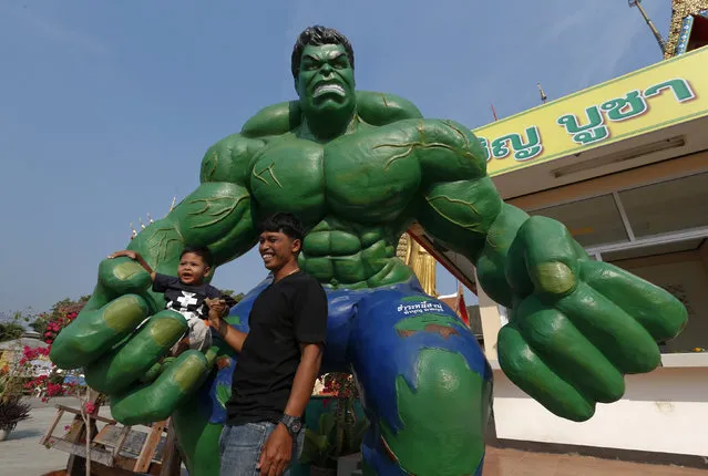 A man and his grandson pose with a statue of comic character the Hulk at Tamru temple in Samut Prakan province, Thailand, March 3, 2016. (Photo by Chaiwat Subprasom/Reuters)