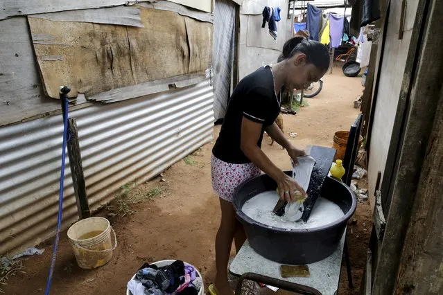 A woman washes clothes during International Women's Day in Asuncion, Paraguay March 8, 2016. (Photo by Jorge Adorno/Reuters)