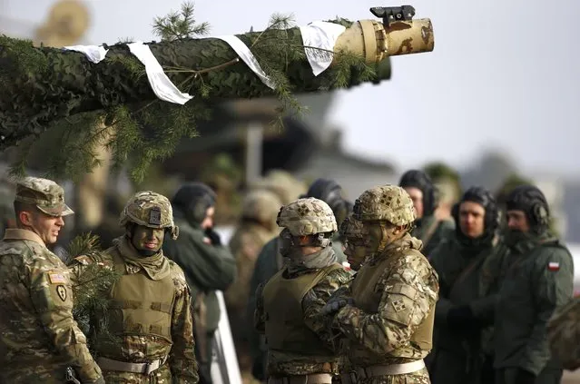 U.S. and Polish army soldiers gather near their tanks after live firing exercise in Zagan, Poland, January 30, 2017. (Photo by Kacper Pempel/Reuters)