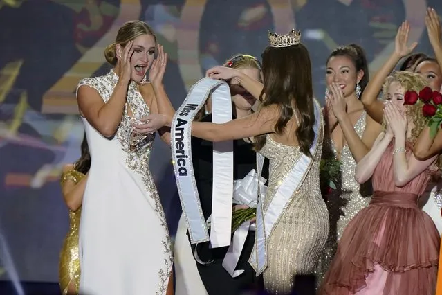Miss Wisconsin Grace Stanke, left, is presented with the Miss America 2023 sash by Miss America 2022 Emma Broyles, center, after Stanke is named the winner of the competition at Mohegan Sun casino, in Uncasville, Conn., Thursday, December 15, 2022. (Photo by Steven Senne/AP Photo)