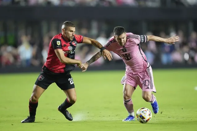 Inter Miami forward Lionel Messi (10) comes under pressure from Newell's Old Boys midfielder Julian Fernandez, left, during the first half of a friendly soccer match, Thursday, February 15, 2024, in Fort Lauderdale, Fla. (Photo by Rebecca Blackwell/AP Photo)