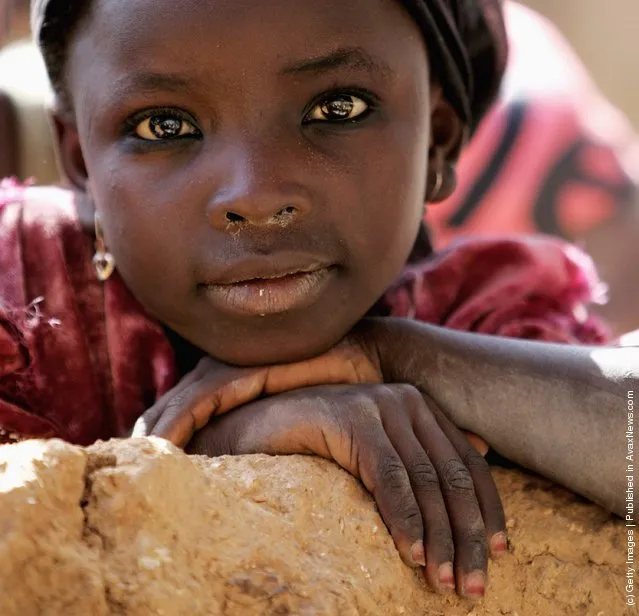 A local girl poses for the camera in Dawakin Kudu village on November 29, 2006 near Freetown, Sierra Leone